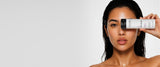Woman holding Zenagen Revolve Women's Shampoo over one eye, showcasing a hair care solution for fine and visibly thinning hair.