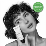 Woman holding evolve shampoo bottle