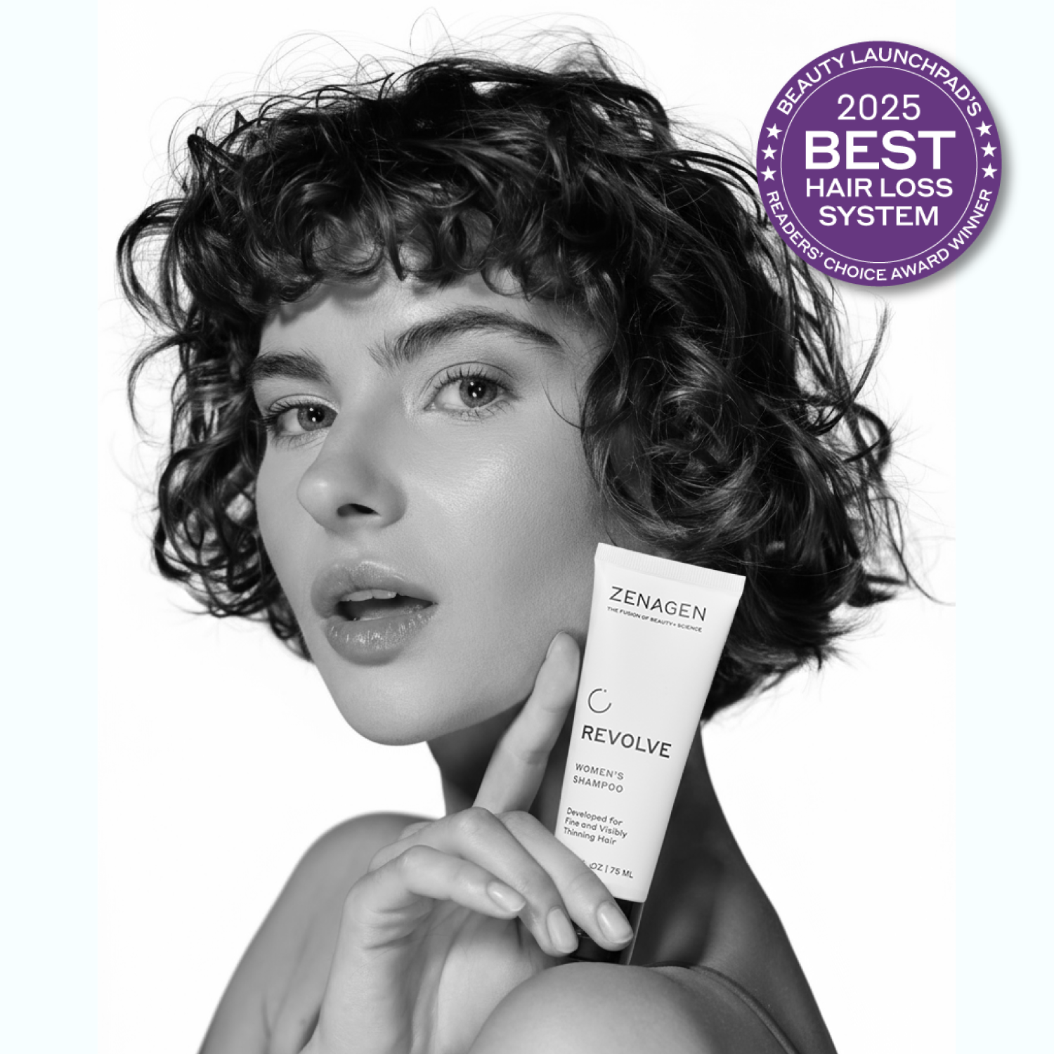 Woman holding a bottle of Zenagen Revolve with a 2025 Best Hair Loss System award badge.