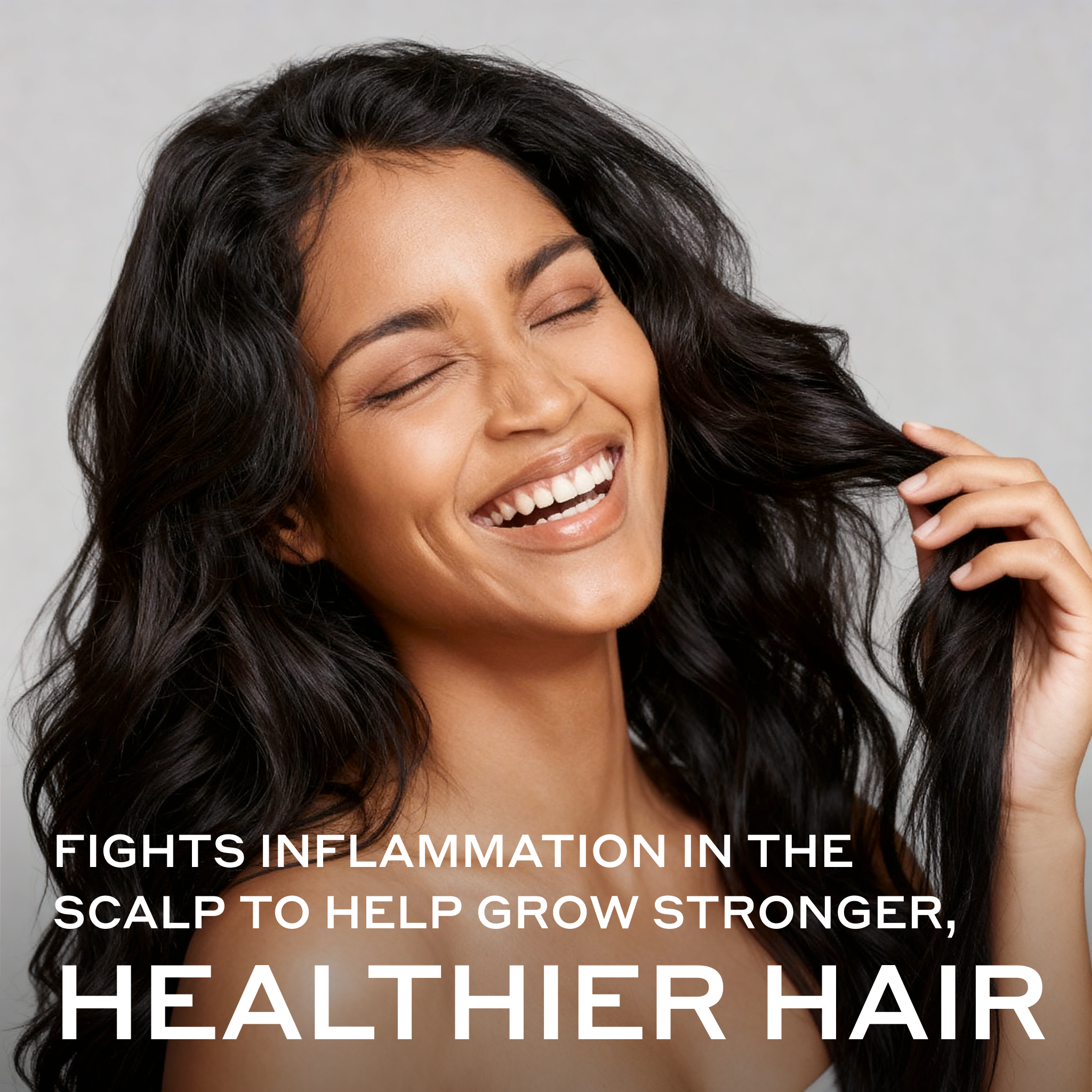 Woman with long, wavy hair smiling against a gray background with text about hair health.