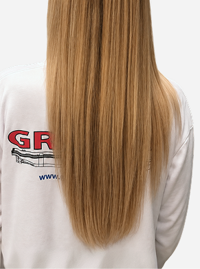 Back view of long blonde hair showing a smooth, shiny finish and sleek, manageable strands after using Zenagen hair care for softness and shine.